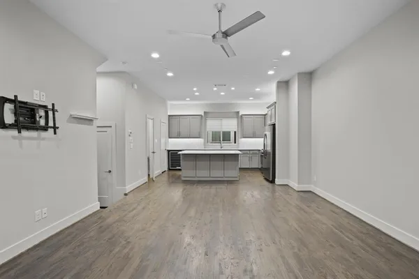 a view of a kitchen with wooden floor and a sink