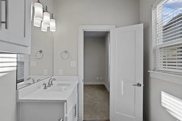 a bathroom with a sink a mirror and a shower