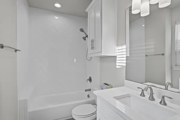 a bathroom with a sink a toilet and bathtub