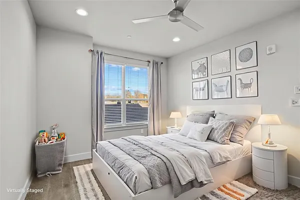 a bedroom with a balcony a bed and a window