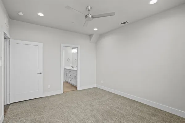 an empty room with a bathroom and a shower
