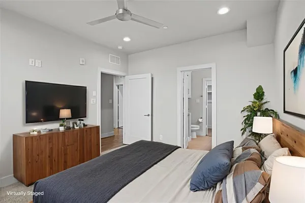 a bedroom with a bed and a flat screen tv