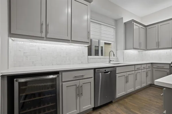 a kitchen with granite countertop cabinets stainless steel appliances and a sink