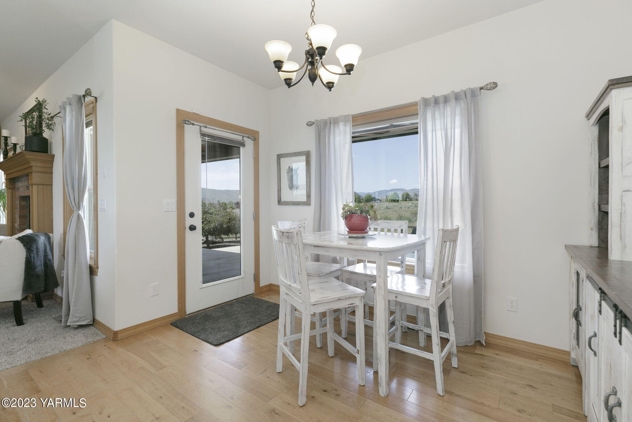 1870 Slavin Road Yakima, WA 98903 - Photo 11 of 27 a view of a dining room with furniture a chandelier and wooden floor