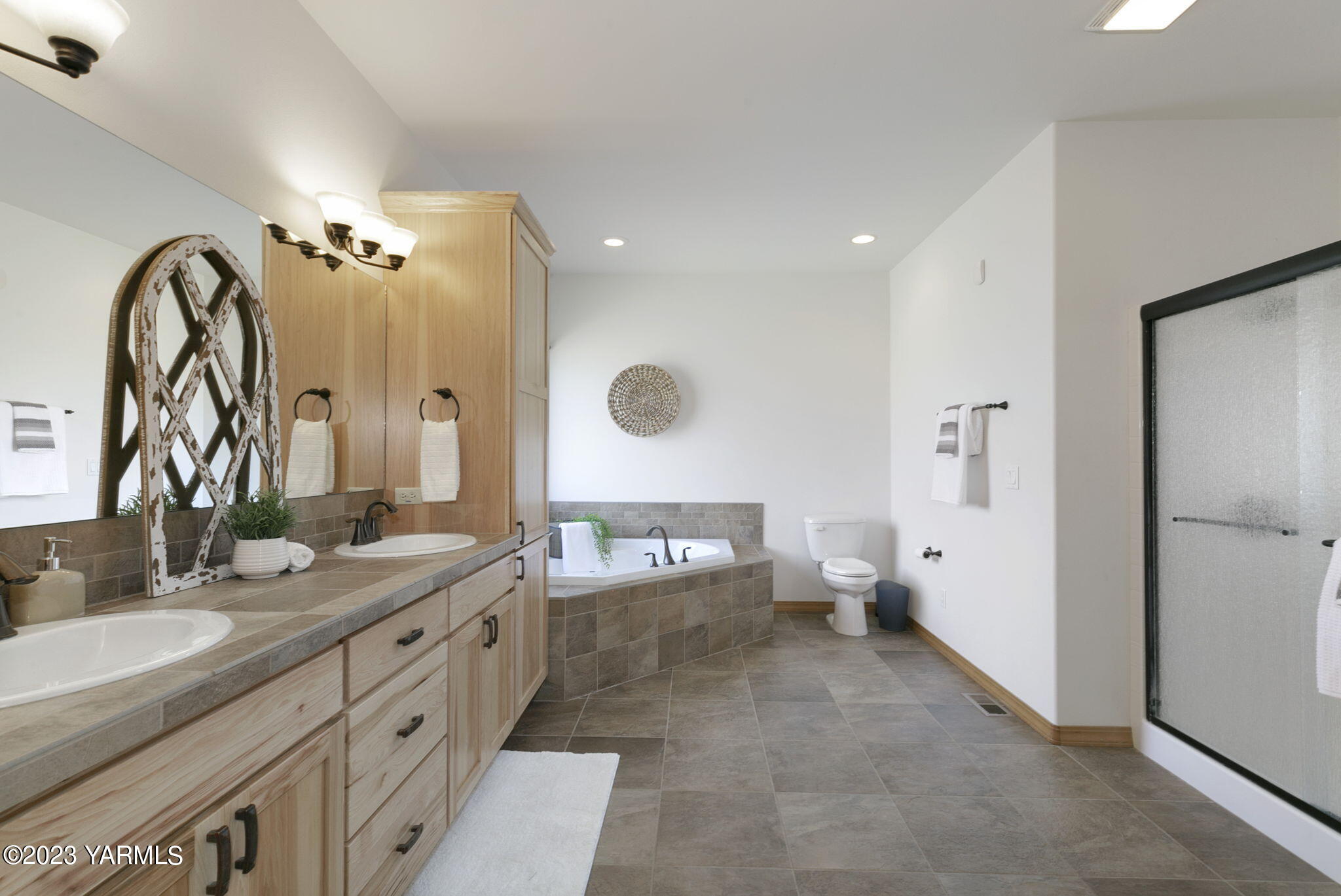 1870 Slavin Road Yakima, WA 98903 - Photo 17 of 27 a spacious bathroom with a double vanity sink a mirror and a shower