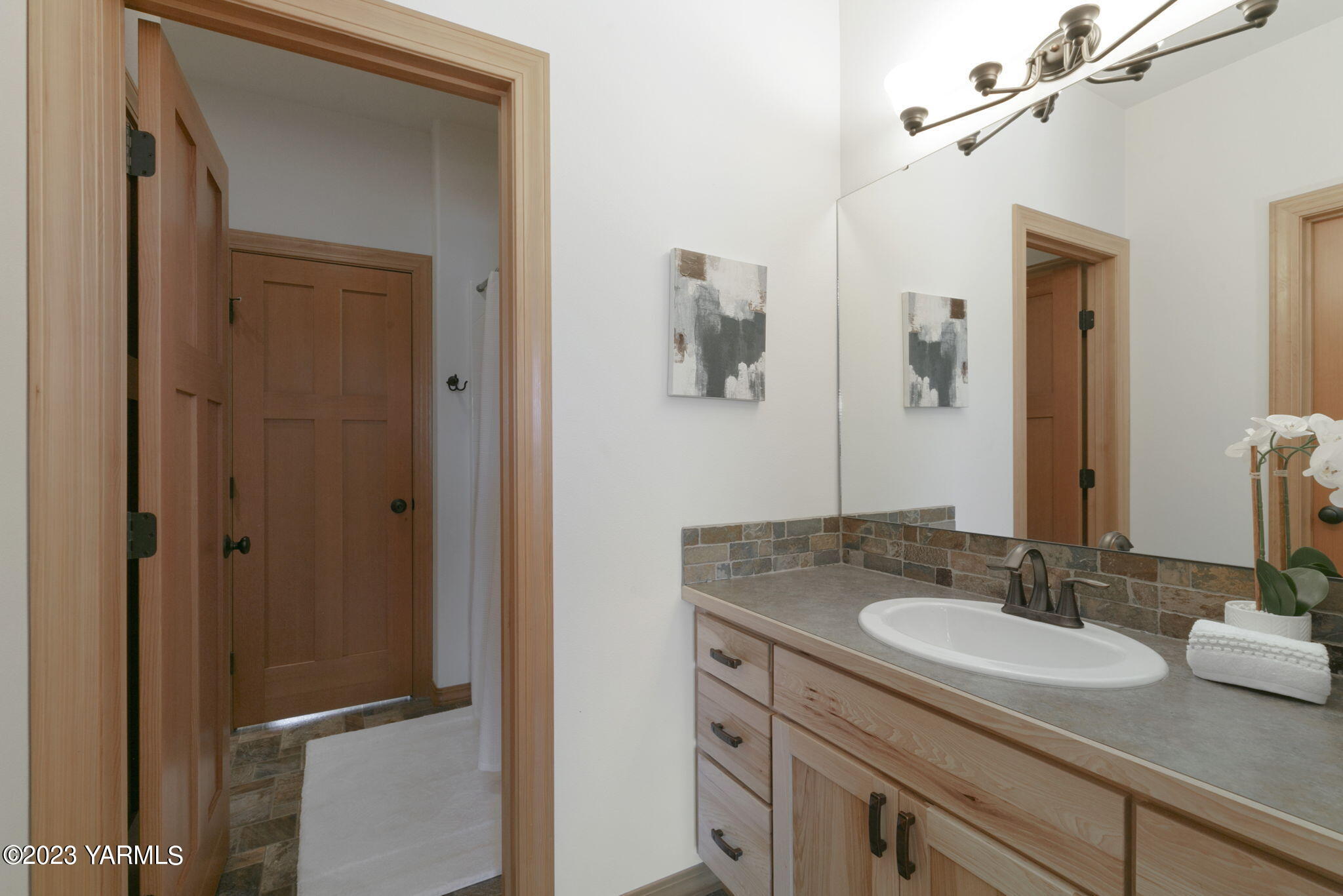1870 Slavin Road Yakima, WA 98903 - Photo 21 of 27 a bathroom with a granite countertop sink and a mirror