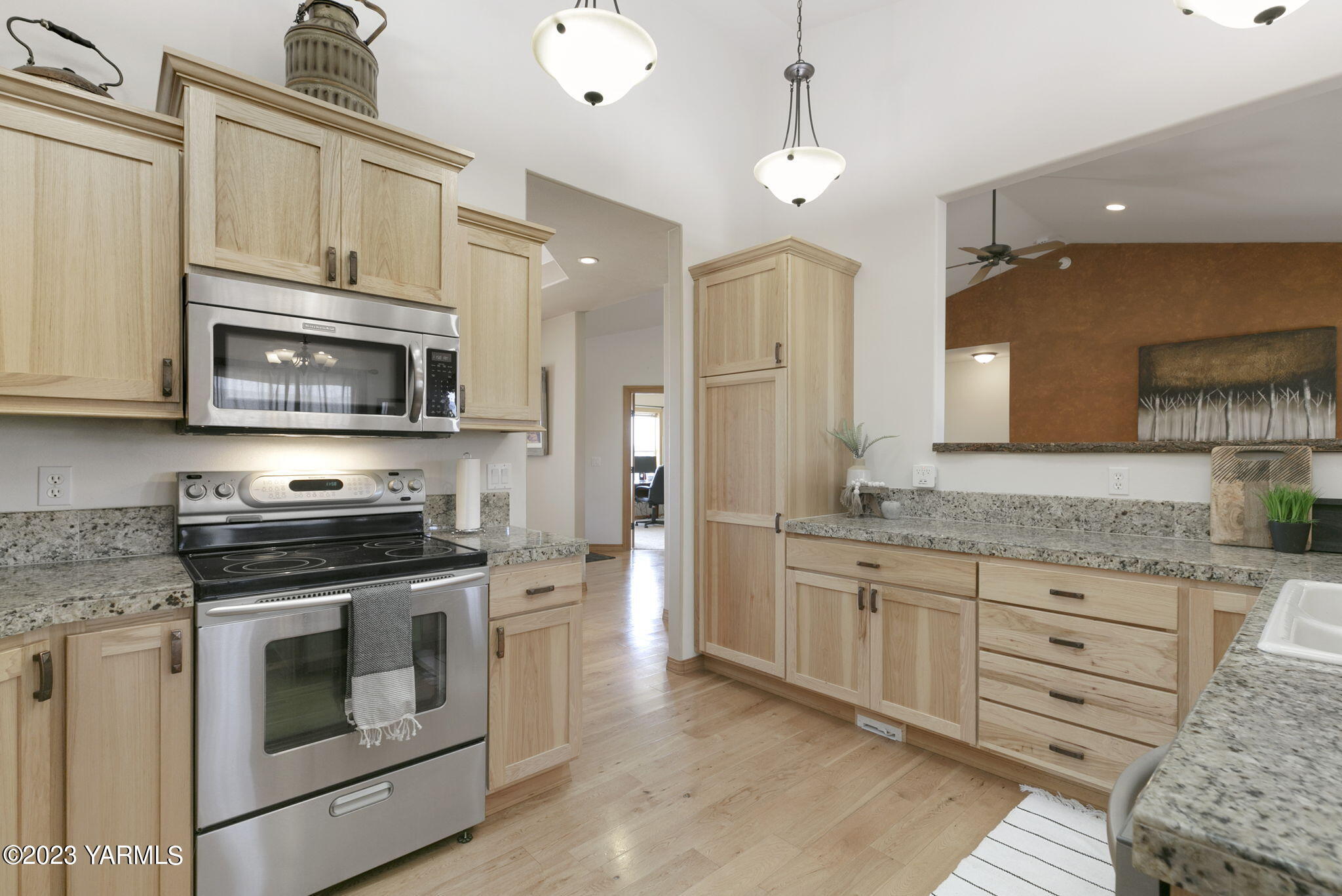 1870 Slavin Road Yakima, WA 98903 - Photo 8 of 27 a kitchen with granite countertop a stove top oven microwave and cabinets