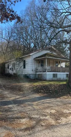 a view of house with a yard