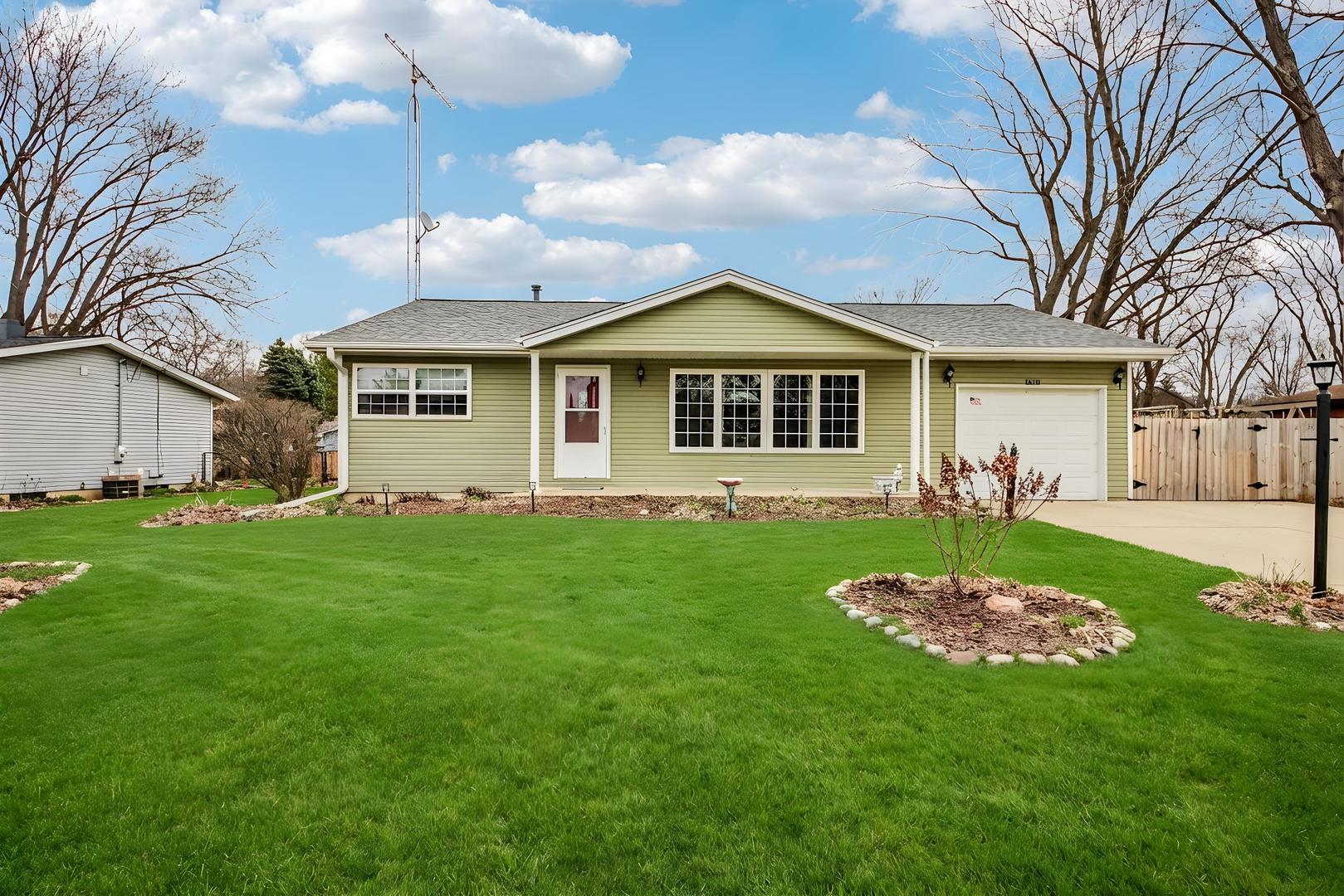 1618 Pine Trail Sycamore, IL 60178 - Photo 1 of 33 a front view of a house with a garden