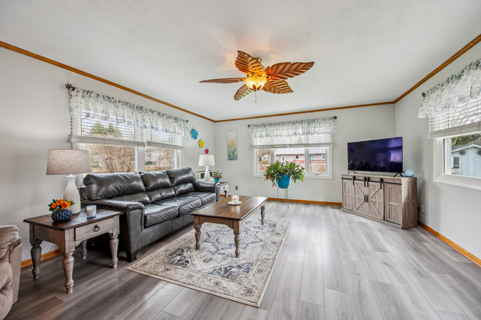 1618 Pine Trail Sycamore, IL 60178 - Photo 15 of 33 a living room with furniture a flat screen tv and a floor to ceiling window