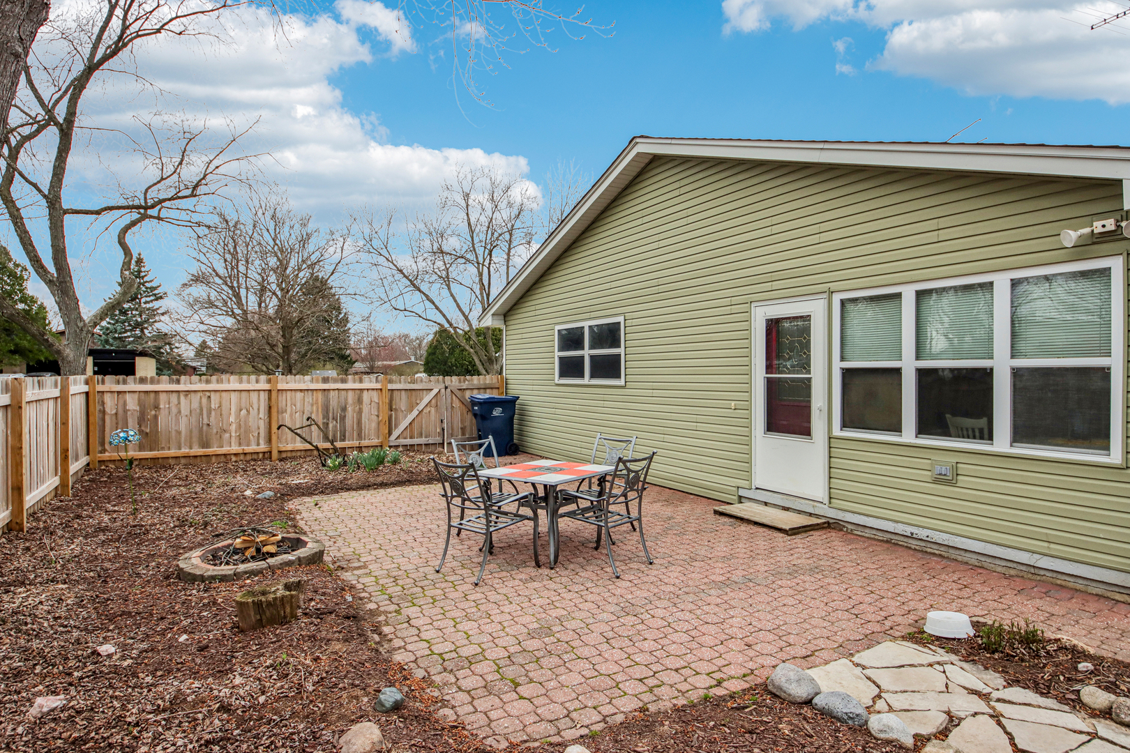 1618 Pine Trail Sycamore, IL 60178 - Photo 27 of 33 a backyard of a house with wooden floor chairs and wooden fence