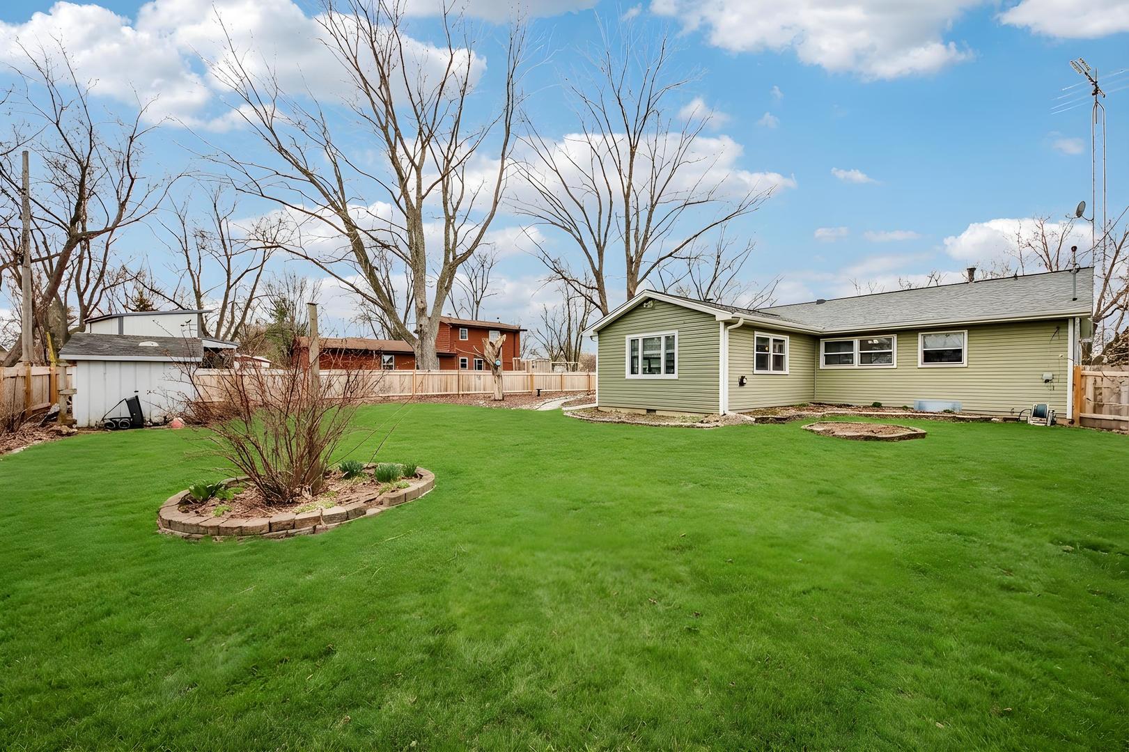 1618 Pine Trail Sycamore, IL 60178 - Photo 30 of 33 a front view of a house with a garden and yard