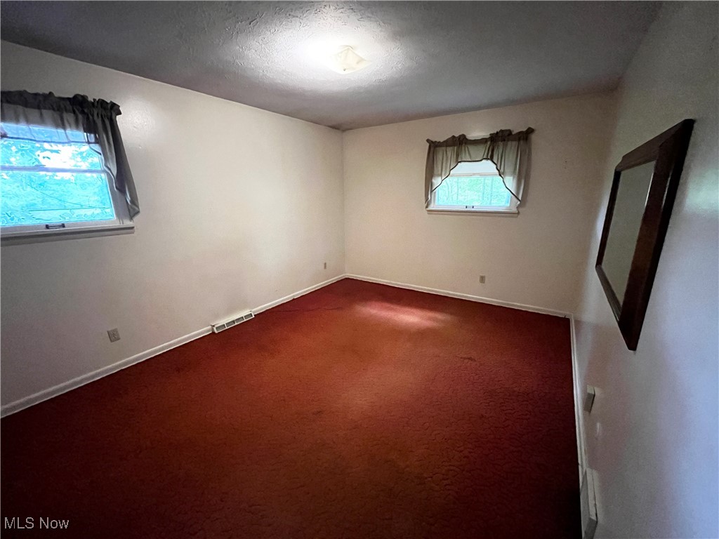 2300 River Road Willoughby, OH 44094 - Photo 17 of 28 Unfurnished room with a textured ceiling and carpet floors