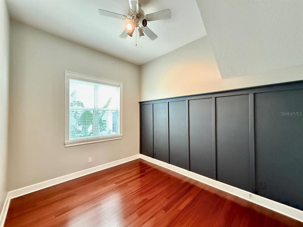6545 Simone Shores Circle Apollo Beach, FL 33572 - Photo 12 of 46 a view of an empty room with wooden floor and a window