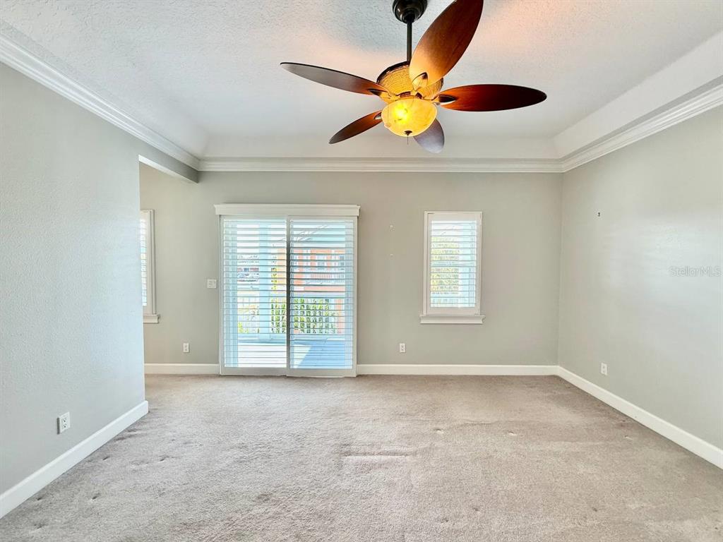 6545 Simone Shores Circle Apollo Beach, FL 33572 - Photo 16 of 46 an empty room with a ceiling fan and window
