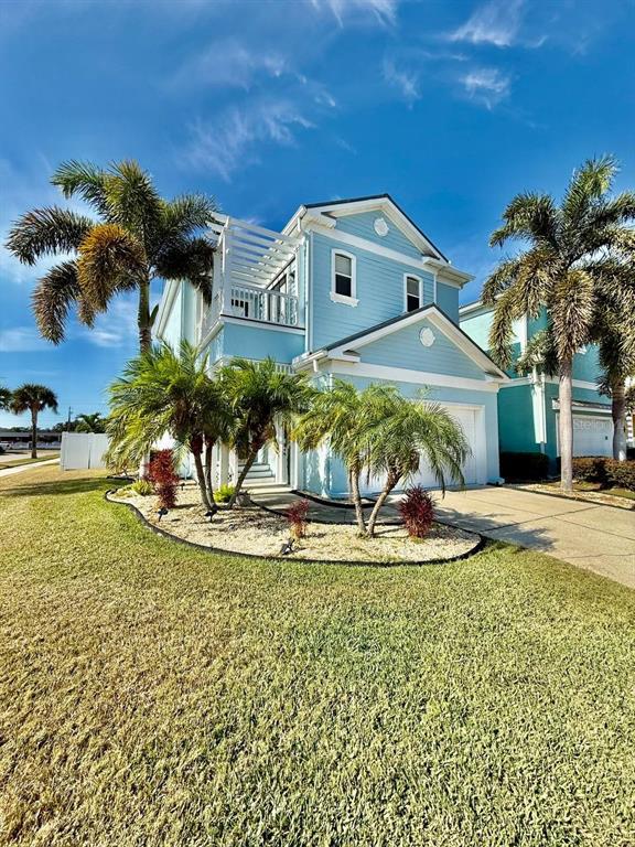 6545 Simone Shores Circle Apollo Beach, FL 33572 - Photo 2 of 46 a view of a white house with a big yard and potted plants