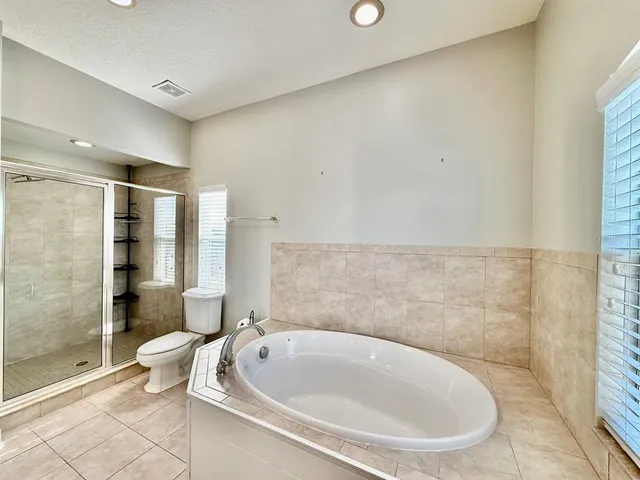 a bathroom with a bathtub and toilet
