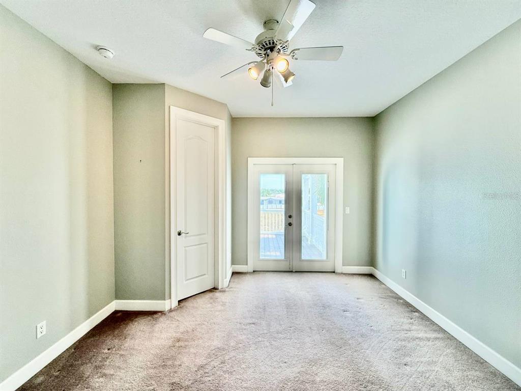6545 Simone Shores Circle Apollo Beach, FL 33572 - Photo 24 of 46 an empty room with windows and fan