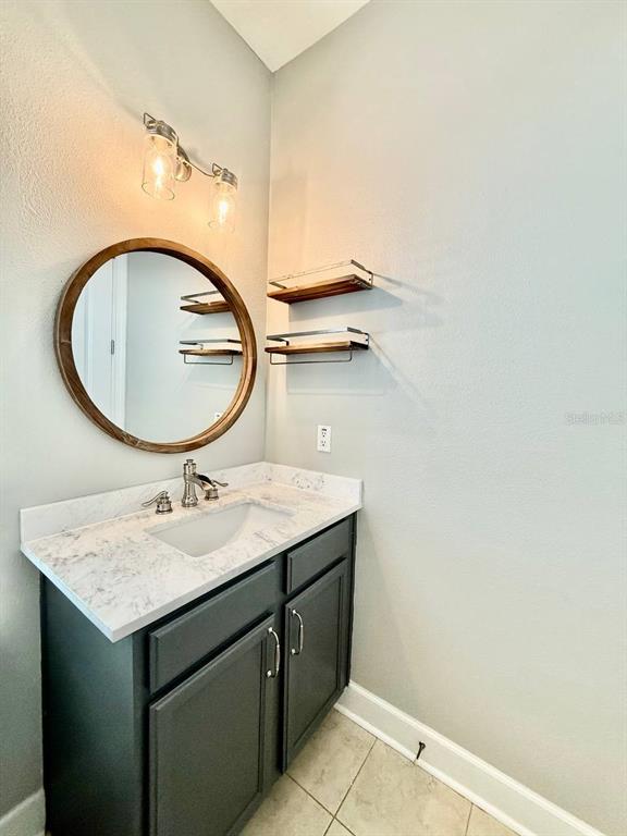 6545 Simone Shores Circle Apollo Beach, FL 33572 - Photo 29 of 46 a bathroom with a granite countertop sink and a mirror