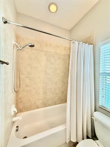 a bathroom with a bath tub and a shower