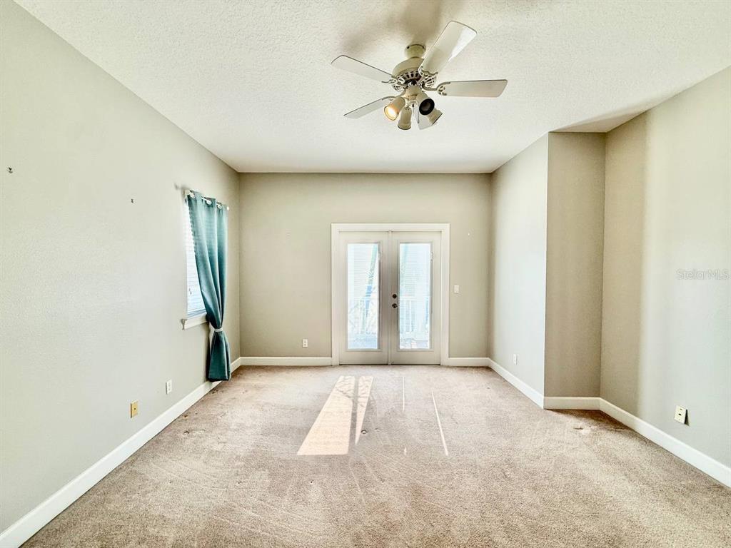 6545 Simone Shores Circle Apollo Beach, FL 33572 - Photo 32 of 46 an empty room with a ceiling fan and window