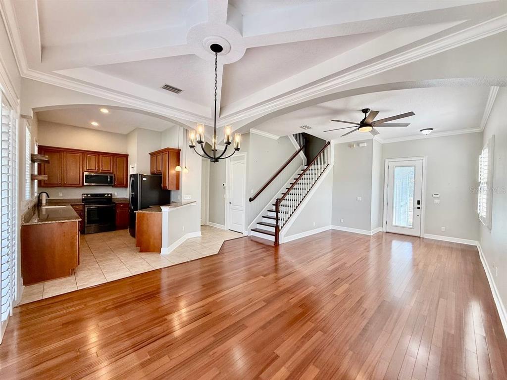 6545 Simone Shores Circle Apollo Beach, FL 33572 - Photo 7 of 46 a view of a kitchen with stainless steel appliances wooden floor and a view of kitchen