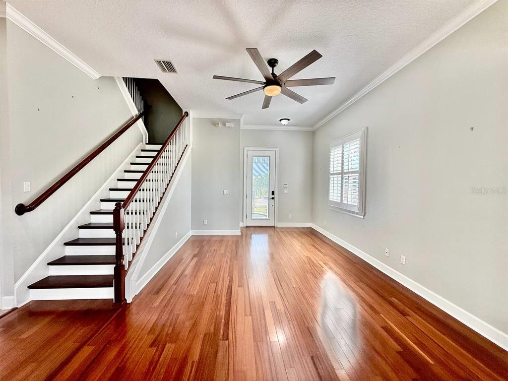 6545 Simone Shores Circle Apollo Beach, FL 33572 - Photo 8 of 46 wooden floor in an empty room with a window