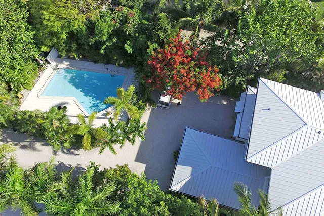 a living room with furniture stairs and a large window