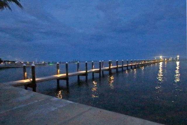 a living room with furniture a flat screen tv and a floor to ceiling window