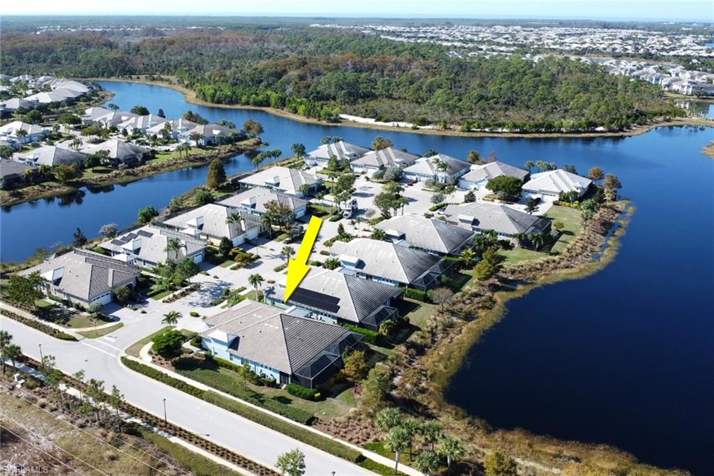 6809 Bequia Way Naples, FL 34113 - Photo 36 of 49 Aerial view of residential area featuring a nearby body of water