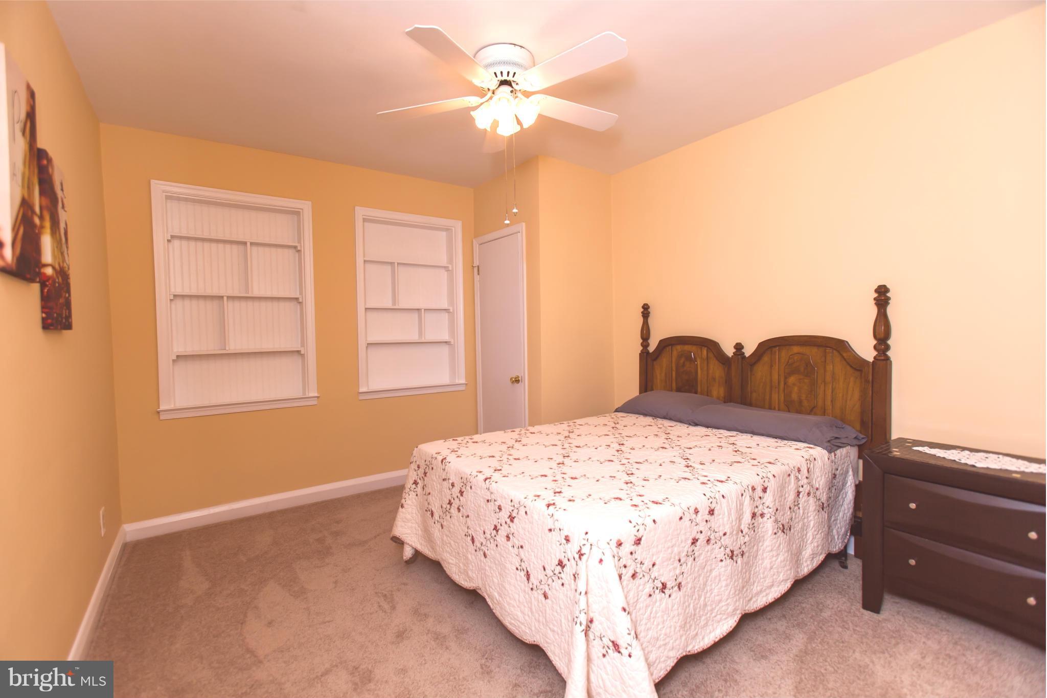 2962 Cornwall Road Dundalk, MD 21222 - Photo 11 of 28 a bedroom with a bed and a chandelier
