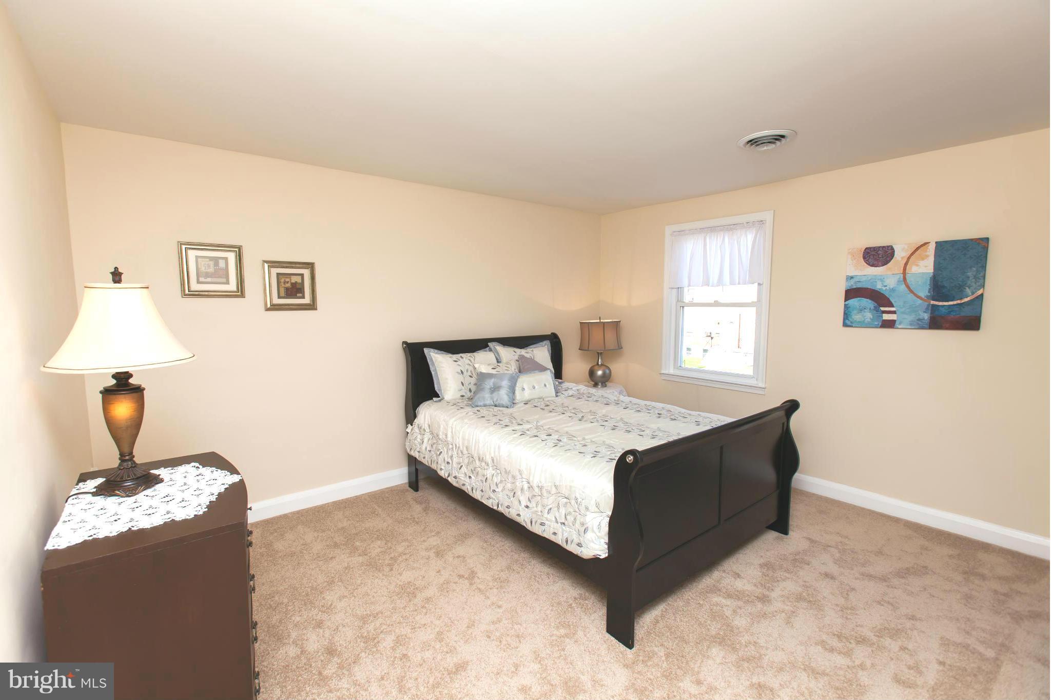 2962 Cornwall Road Dundalk, MD 21222 - Photo 15 of 28 a bedroom with a bed and a window