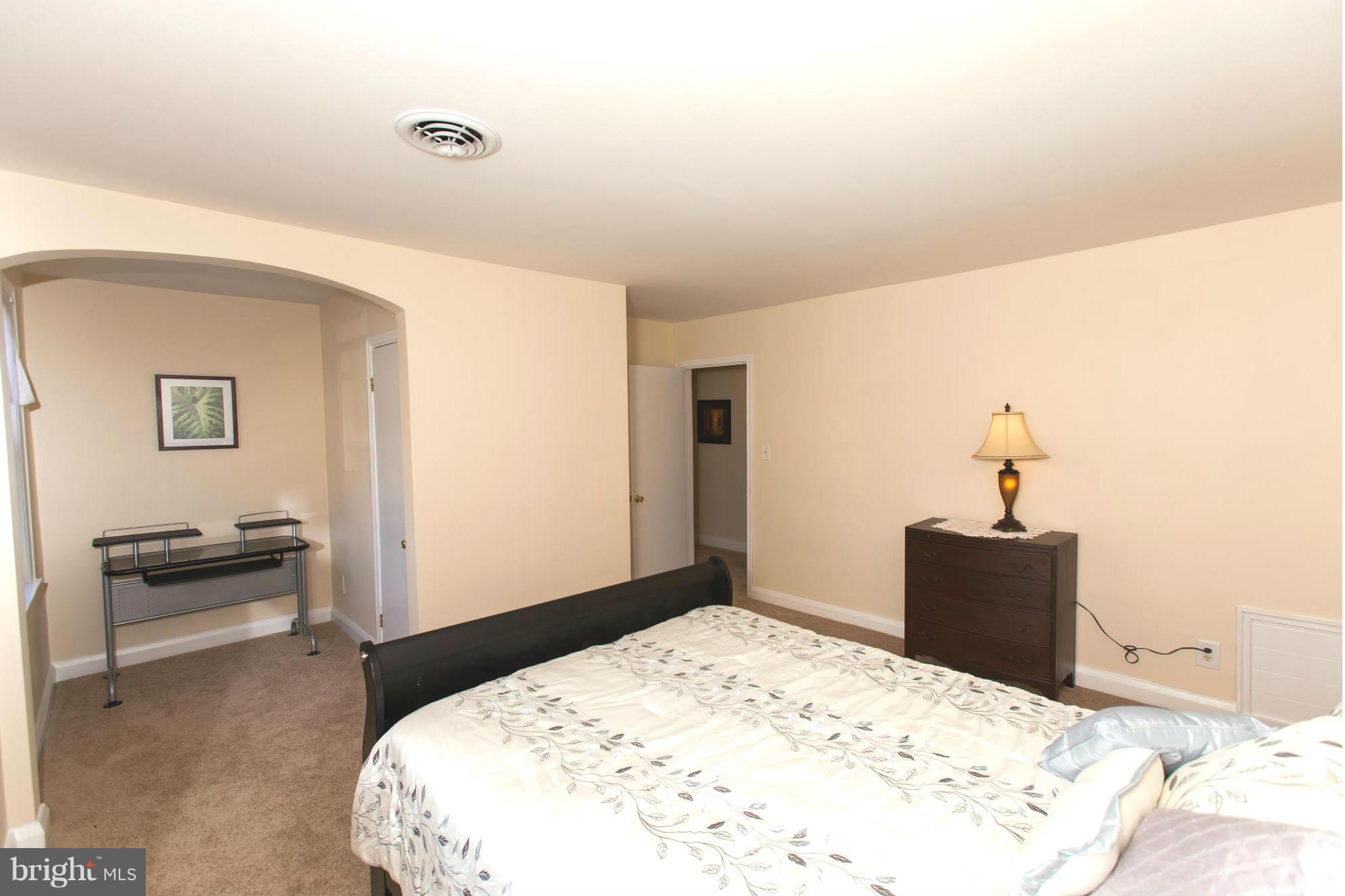 2962 Cornwall Road Dundalk, MD 21222 - Photo 17 of 28 a bedroom with a bed and a chair