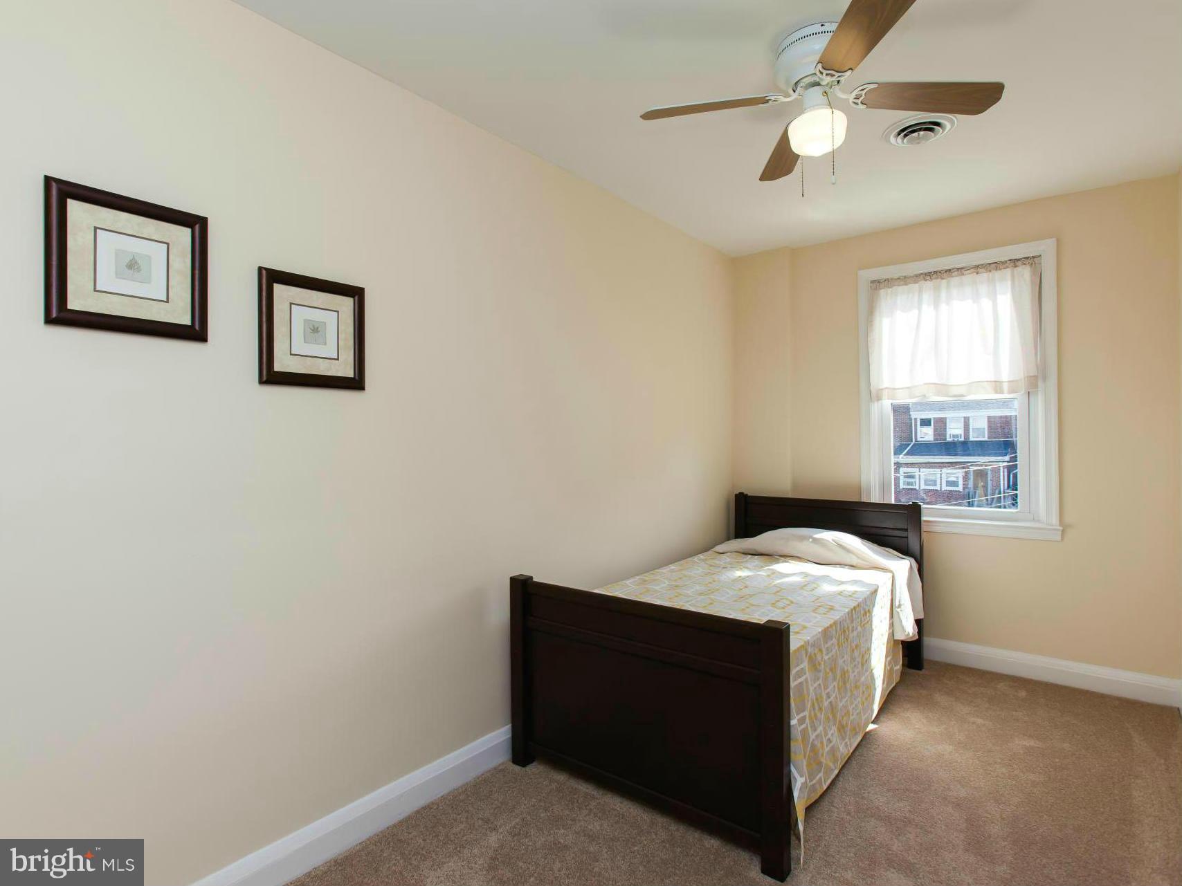 2962 Cornwall Road Dundalk, MD 21222 - Photo 22 of 28 a bed sitting in a bedroom next to a window