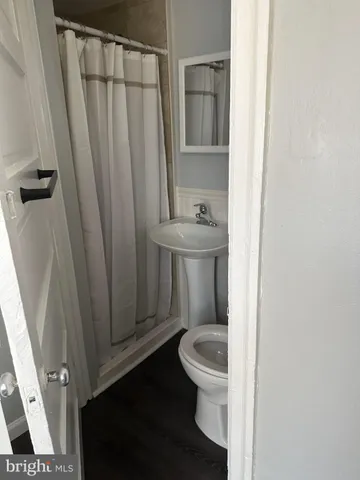 a white toilet sitting next to a sink