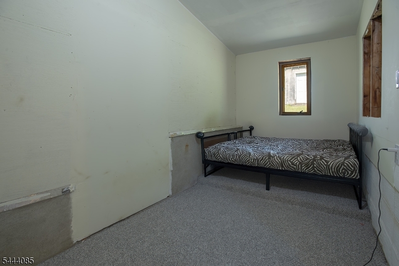 79 Lake Wallkill Road Vernon, NJ 07461 - Photo 19 of 27 a bedroom with a bed and a window