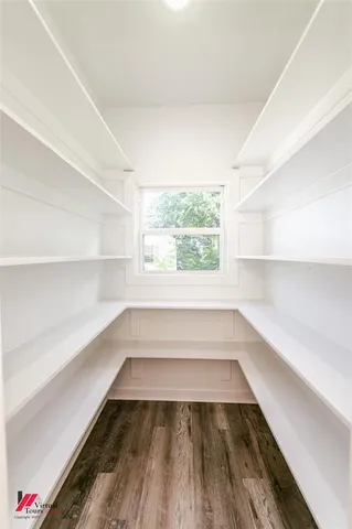 a view of a room with wooden floor and window