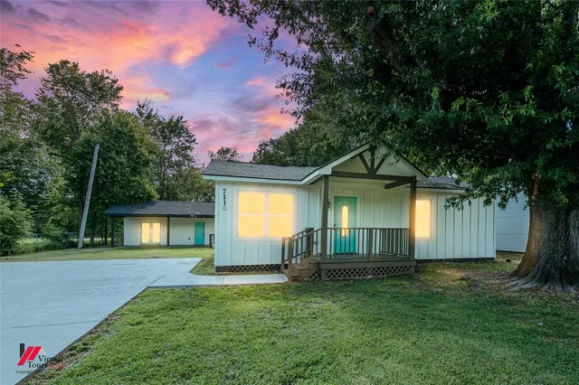 a front view of a house with a garden and yard