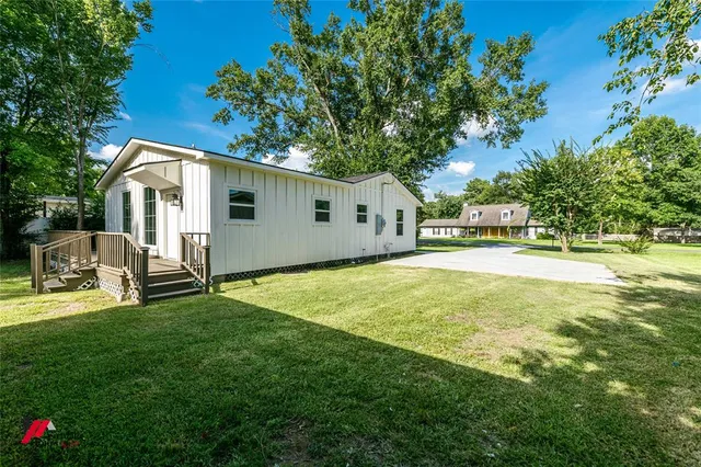 a front view of house with yard and trees