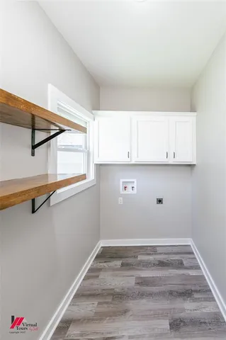 a view of a kitchen with wooden floor and cabinets