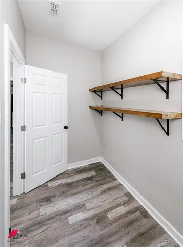 a view of a room with wooden floor