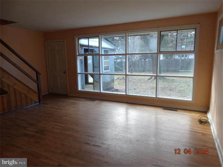 12 Devonwood Road Wayne, PA 19087 - Photo 7 of 16 an empty room with wooden floor and windows
