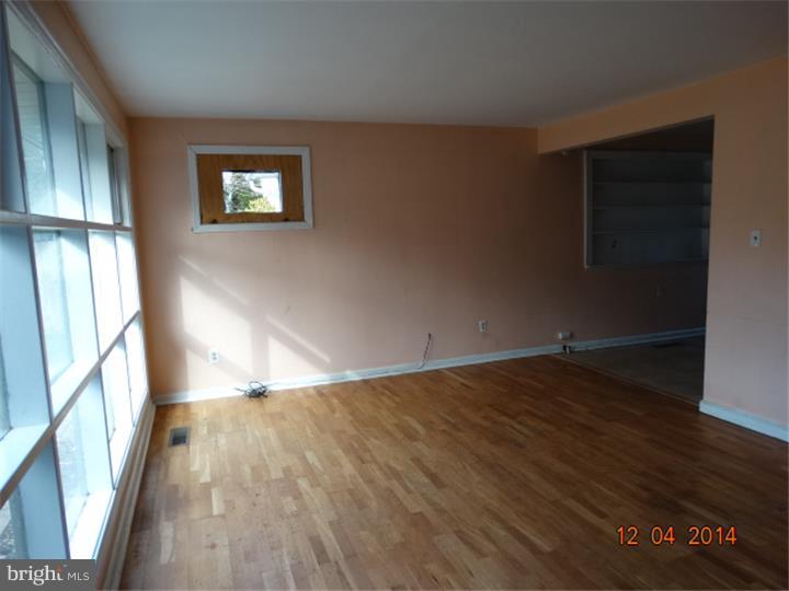 12 Devonwood Road Wayne, PA 19087 - Photo 9 of 16 a view of an empty room with wooden floor and a window