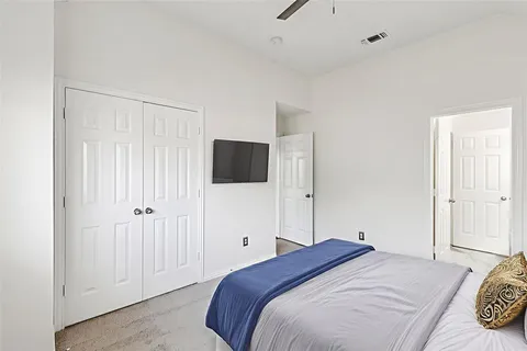 a bedroom with a bed and a flat tv screen