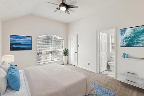 a bedroom with a large bed and a window