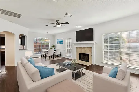 a living room with furniture a fireplace and a flat screen tv