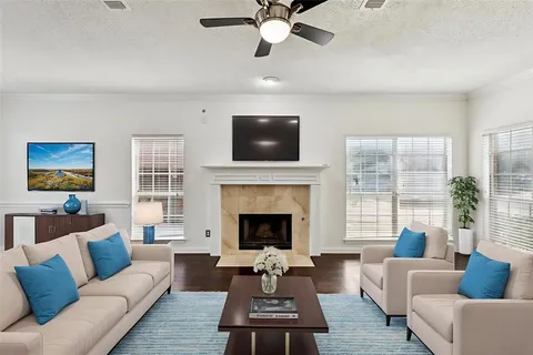 a living room with furniture a fireplace and a flat screen tv