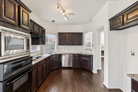 a kitchen with stainless steel appliances granite countertop a stove and a refrigerator