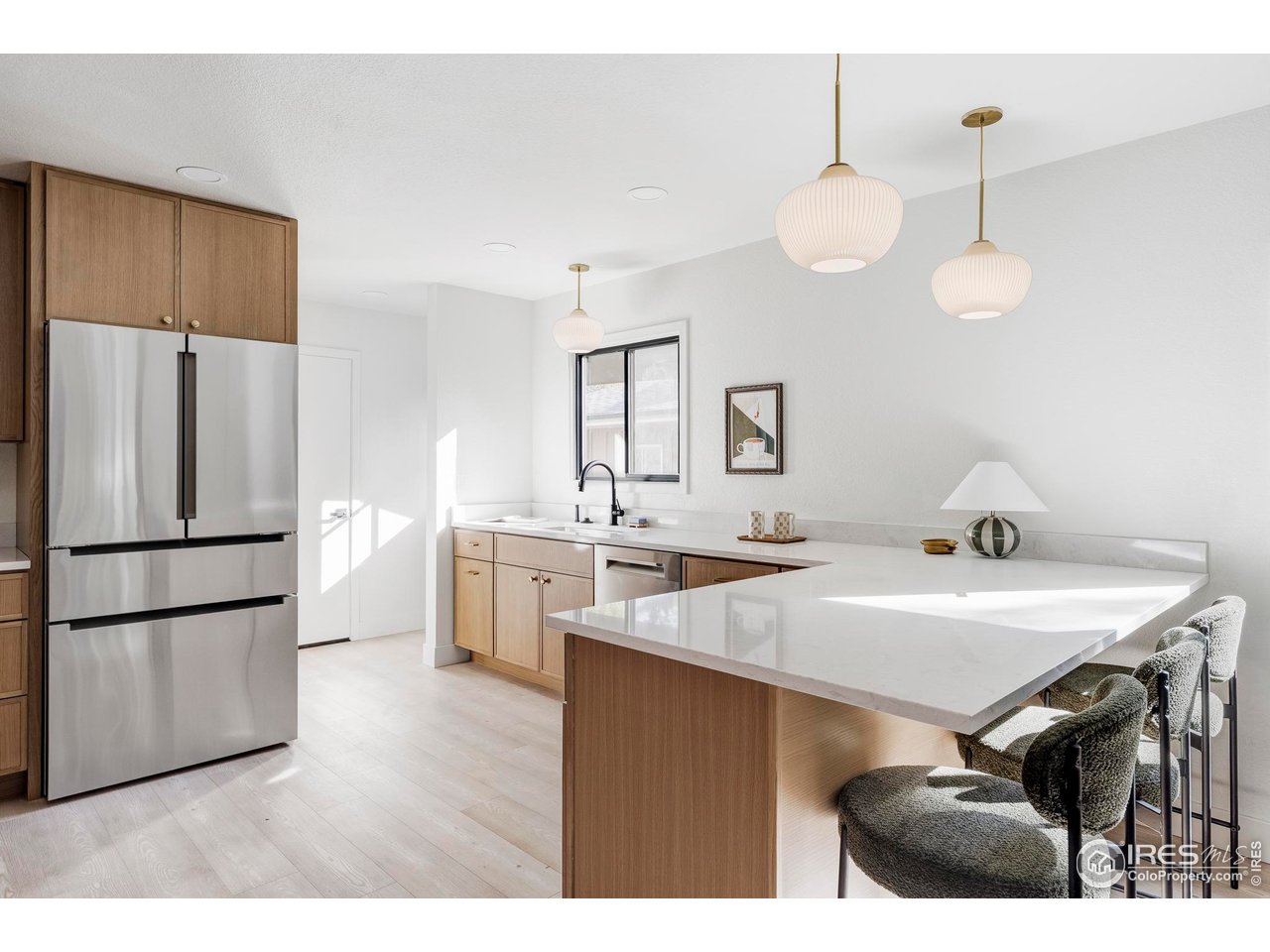 1112 Robertson Street Fort Collins, CO 80524 - Photo 14 of 40 a kitchen with a sink a refrigerator a stove and white cabinets with wooden floor