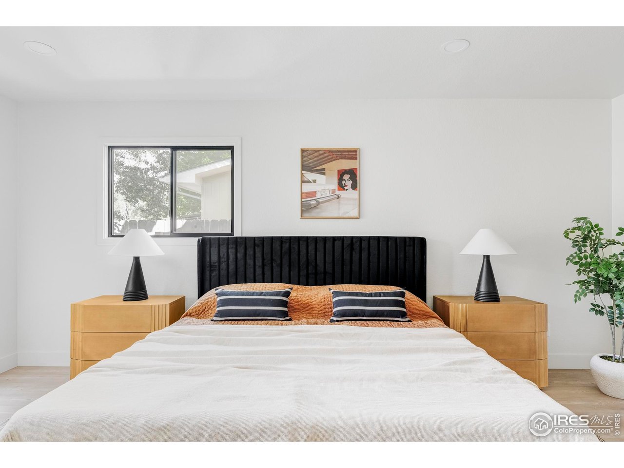 1112 Robertson Street Fort Collins, CO 80524 - Photo 20 of 40 a bedroom with a bed and wooden floor